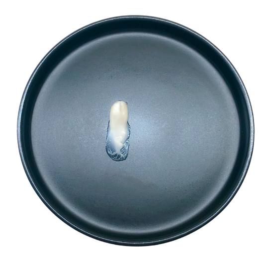 Time Freeze Facial Cream content on a black plate, showcasing the viscosity and texture of the serum.