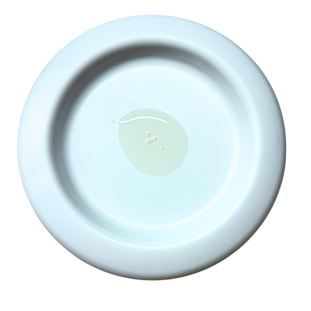 A round, shallow ceramic dish or saucer in a very pale icy blue color, photographed from directly above on a solid white background.