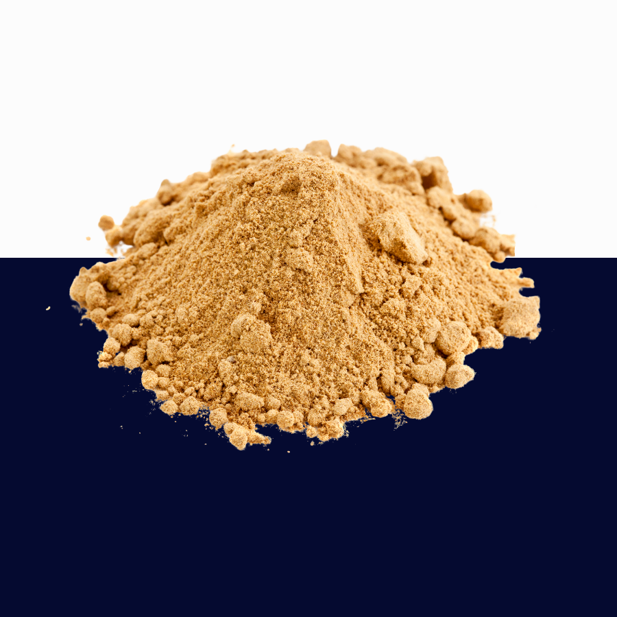 A mound of fine tan-brown powder or granules centered on a split white and dark navy background.