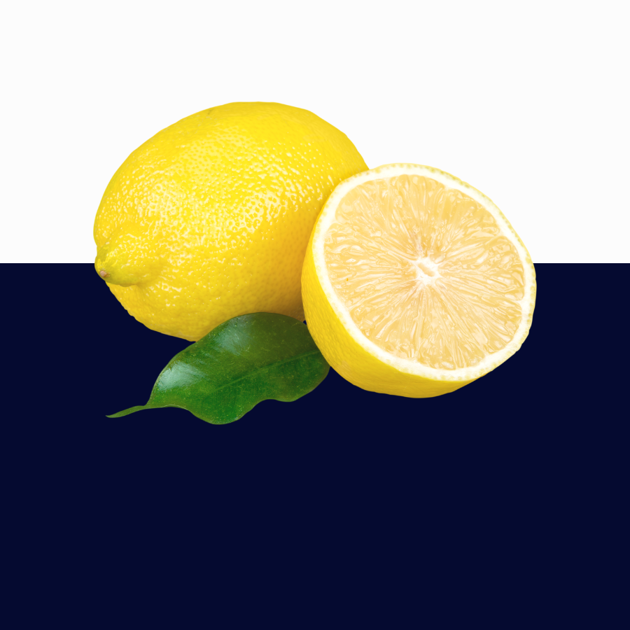 A whole yellow lemon and a halved lemon with a green leaf, shown against a split white and dark navy background.