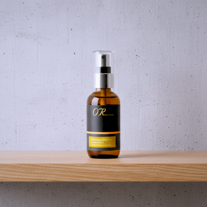 An amber glass spray bottle with a black and gold label reading 'OR Better' and 'Squamous Cell Carcinoma Cream', standing on a light wood shelf against a textured light gray wall.