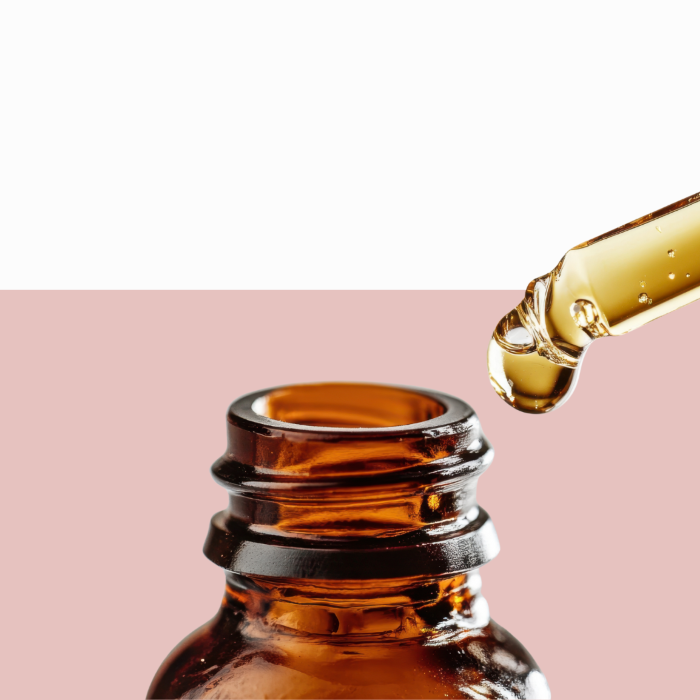 Amber glass dropper bottle with organic essential oil.