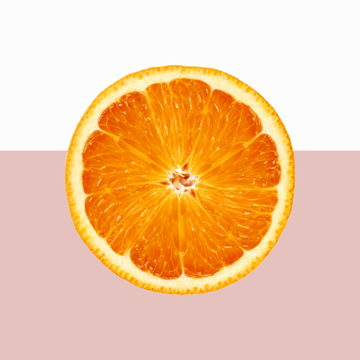 Sliced orange on a two-tone pink background